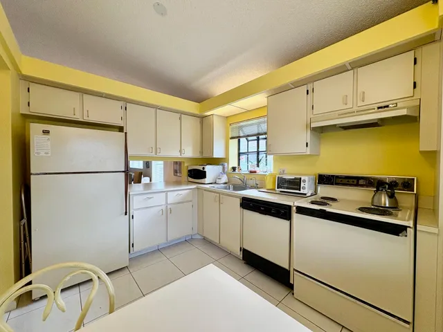 a kitchen with appliances cabinets and a sink