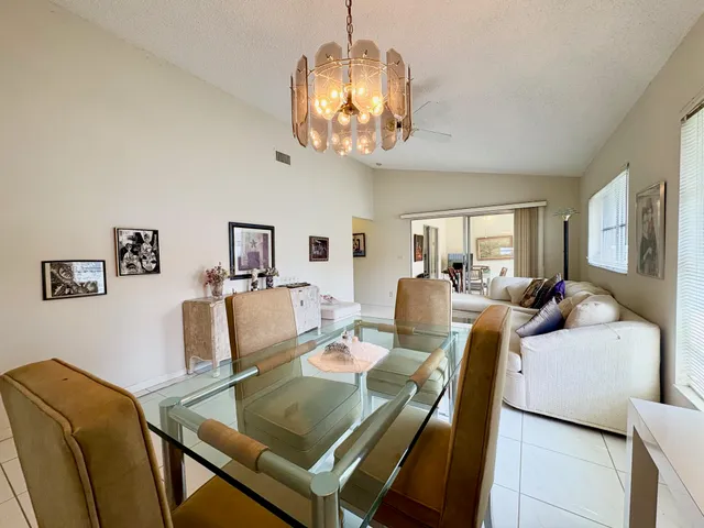 a view of a dining room with furniture and a chandelier