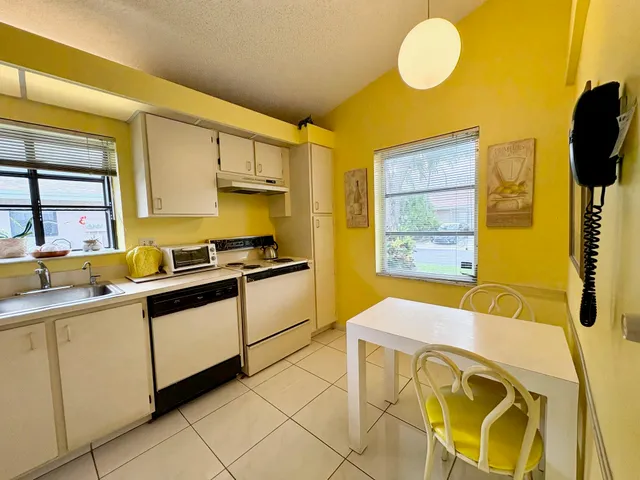 a kitchen with a sink and wooden cabinets