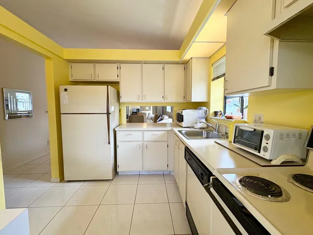 a kitchen with a refrigerator a stove a sink dishwasher and a refrigerator