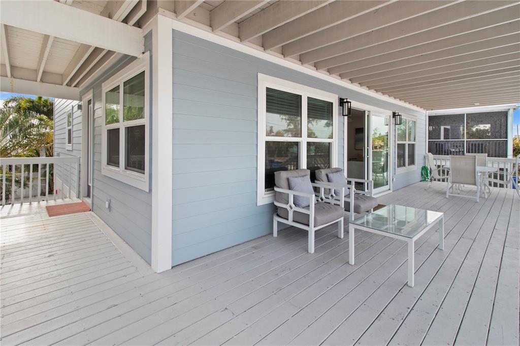 403 North Bay Boulevard Anna Maria, FL 34216 - Photo 12 of 58 a view of a patio with table and chairs and wooden floor