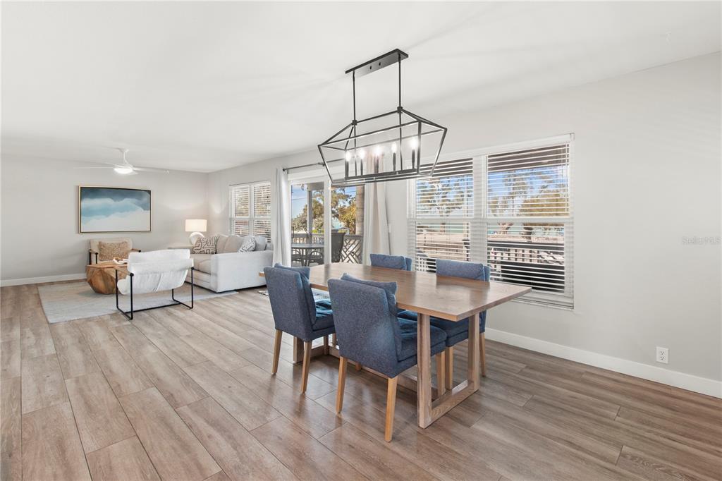 403 North Bay Boulevard Anna Maria, FL 34216 - Photo 14 of 58 a view of a dining room with furniture window and wooden floor