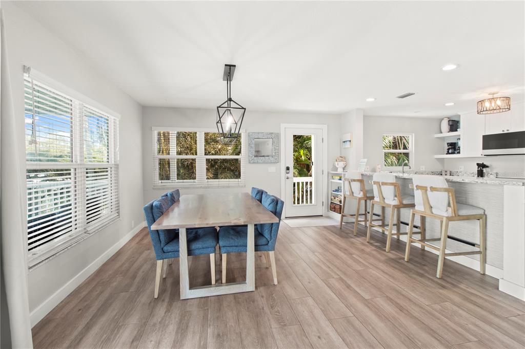 403 North Bay Boulevard Anna Maria, FL 34216 - Photo 16 of 58 a view of a dining room with furniture window and wooden floor