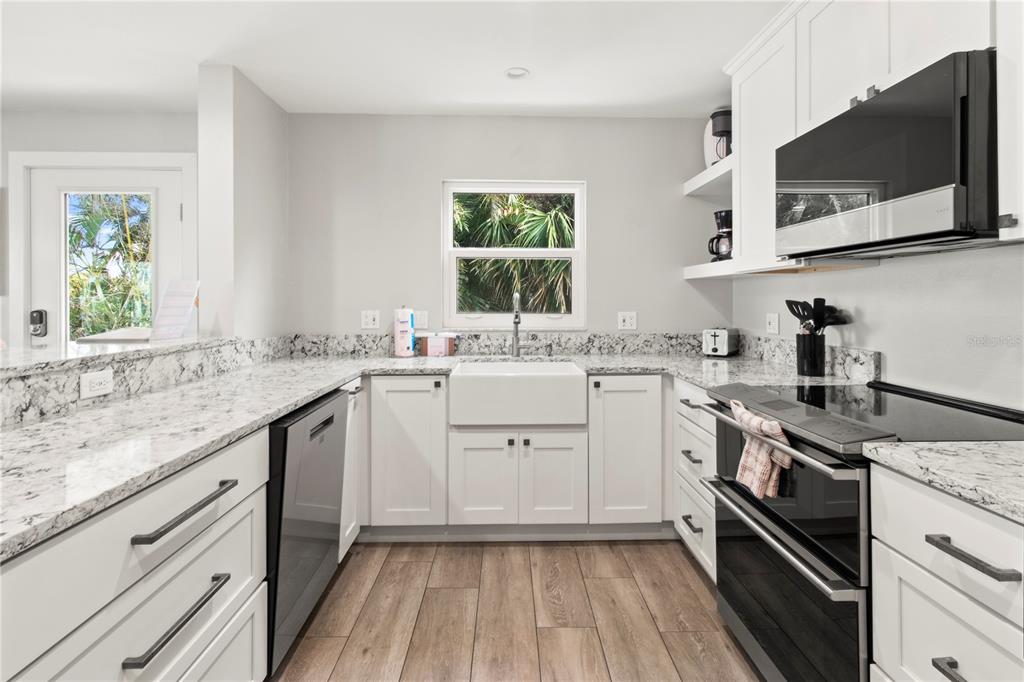 403 North Bay Boulevard Anna Maria, FL 34216 - Photo 19 of 58 a kitchen with a sink stove and microwave