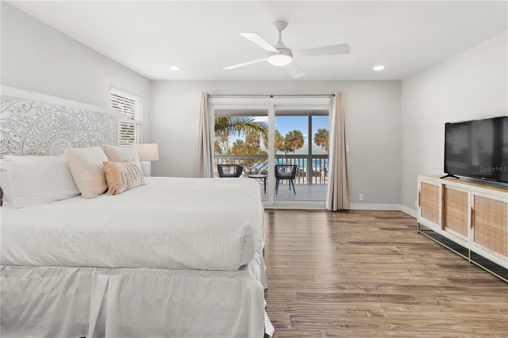 403 North Bay Boulevard Anna Maria, FL 34216 - Photo 26 of 58 a bedroom with a bed and a flat screen tv