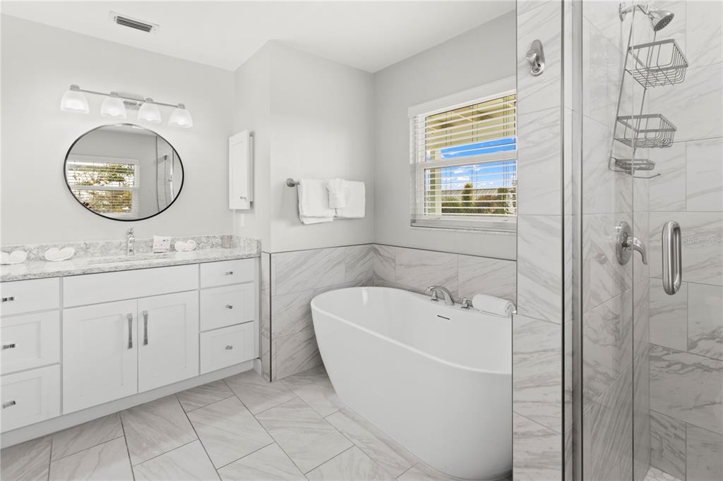 403 North Bay Boulevard Anna Maria, FL 34216 - Photo 29 of 58 a spacious bathroom with a double vanity sink mirror and bathtub