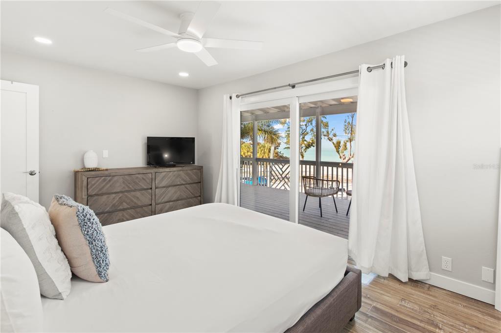 403 North Bay Boulevard Anna Maria, FL 34216 - Photo 31 of 58 a bedroom with a bed and a large window