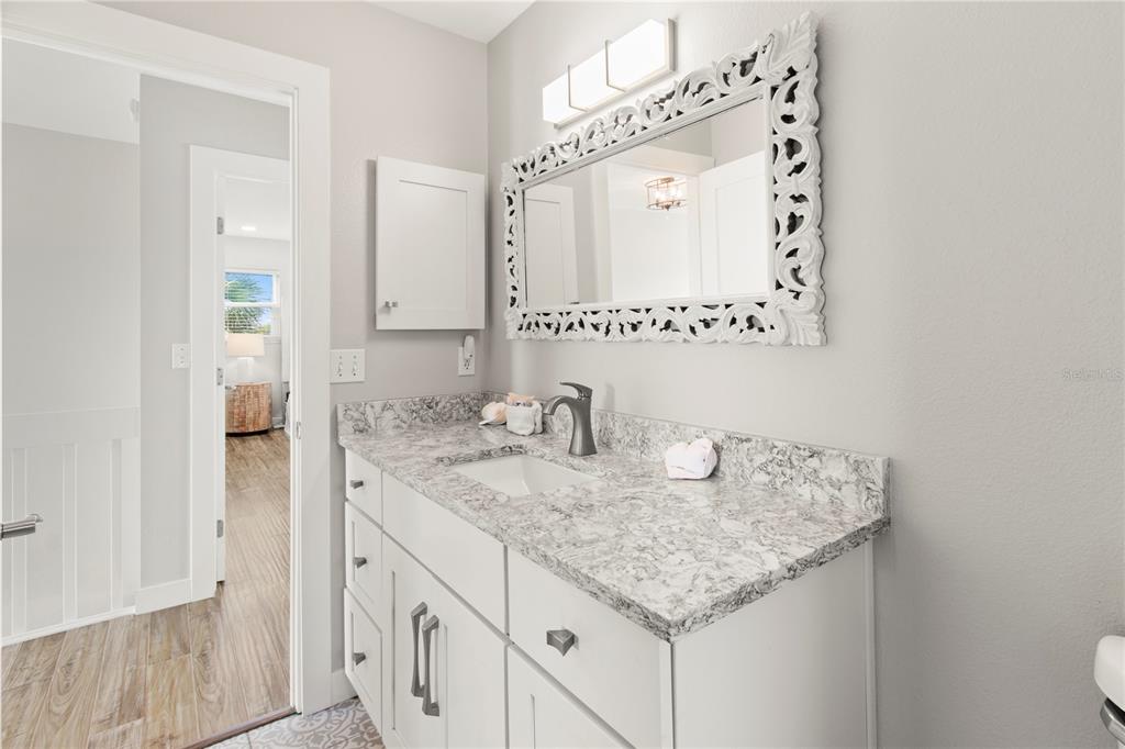403 North Bay Boulevard Anna Maria, FL 34216 - Photo 35 of 58 a bathroom with a granite countertop sink and a mirror