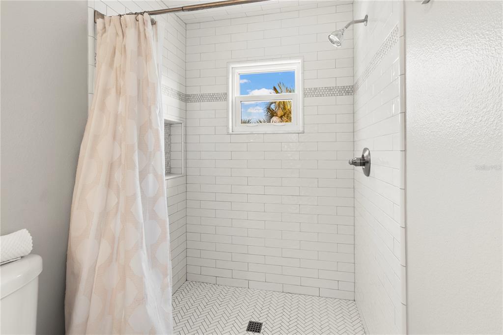 403 North Bay Boulevard Anna Maria, FL 34216 - Photo 36 of 58 a bathroom with a shower