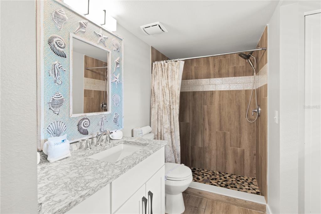 403 North Bay Boulevard Anna Maria, FL 34216 - Photo 41 of 58 a bathroom with a granite countertop sink toilet and shower