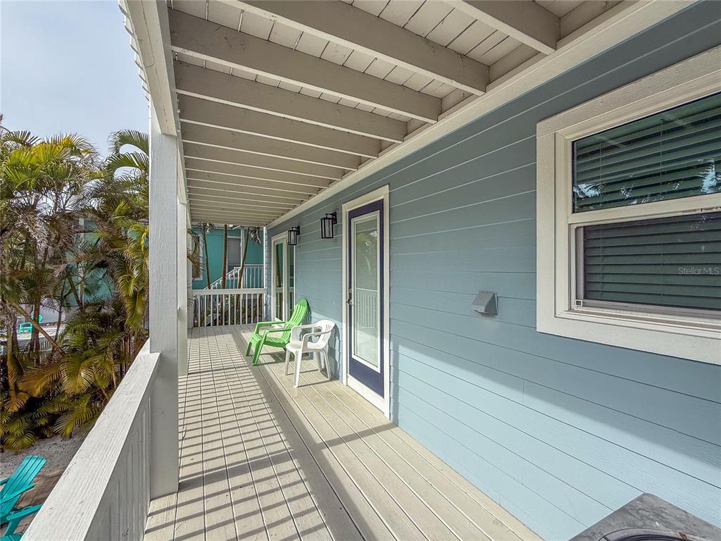 403 North Bay Boulevard Anna Maria, FL 34216 - Photo 54 of 58 a balcony with wooden floor table and chairs