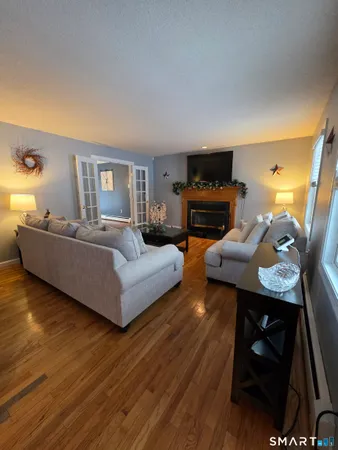 a living room with furniture and a wooden floor