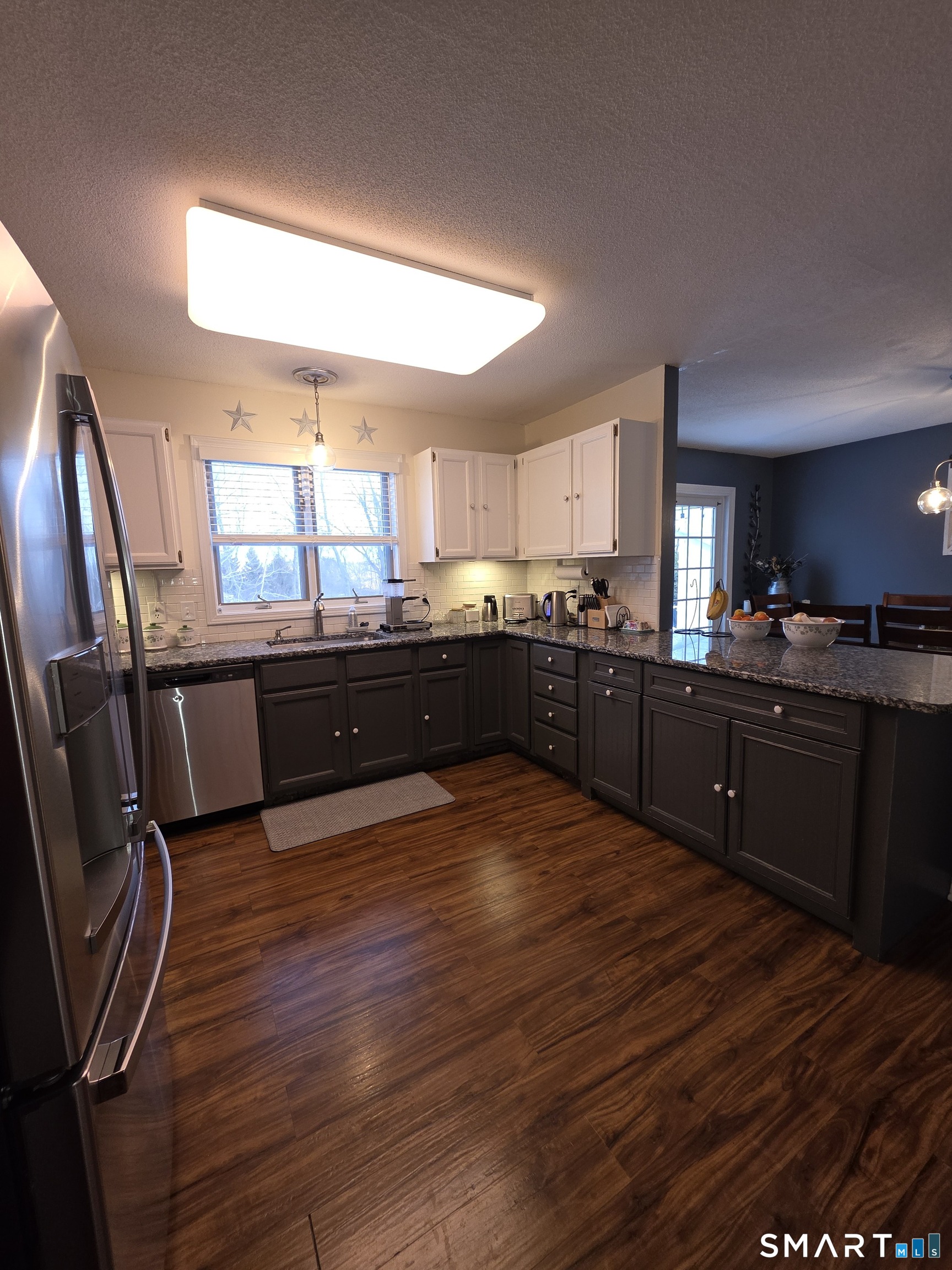 83 Chelsea Court Torrington, CT 06790 - Photo 15 of 39 a large kitchen with wooden floors and stainless steel appliances