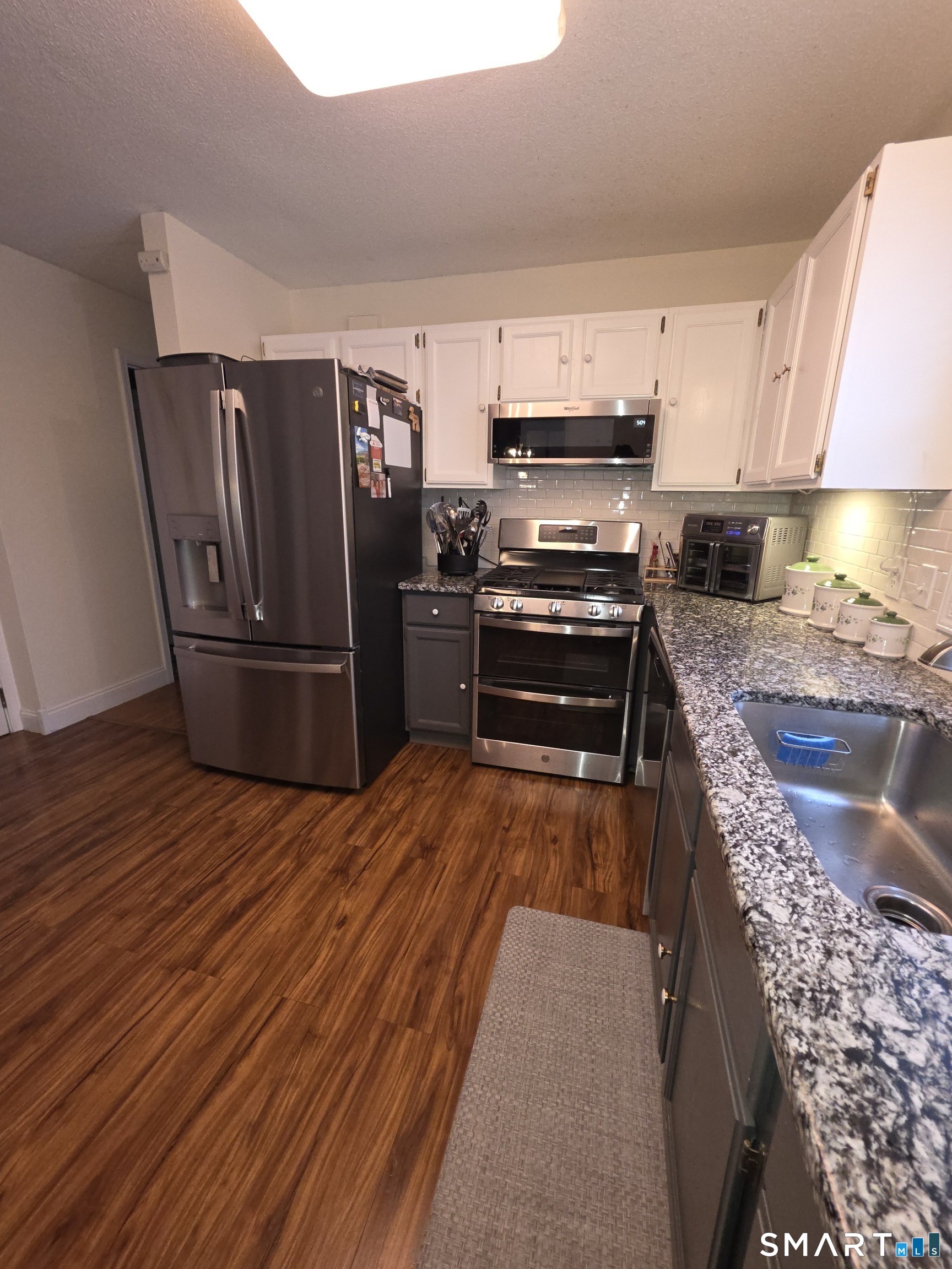 83 Chelsea Court Torrington, CT 06790 - Photo 17 of 39 a kitchen with stainless steel appliances granite countertop a refrigerator stove and oven