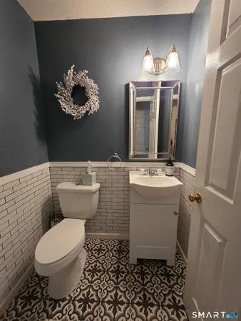 a bathroom with a sink toilet and mirror