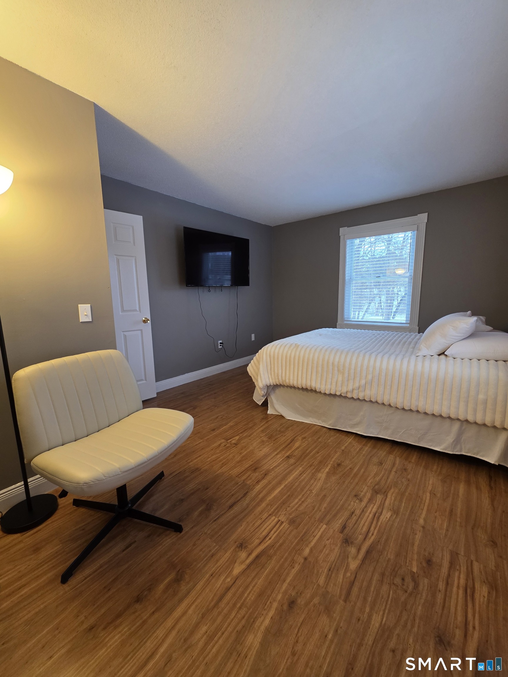 83 Chelsea Court Torrington, CT 06790 - Photo 24 of 39 a bedroom with a bed and a chair