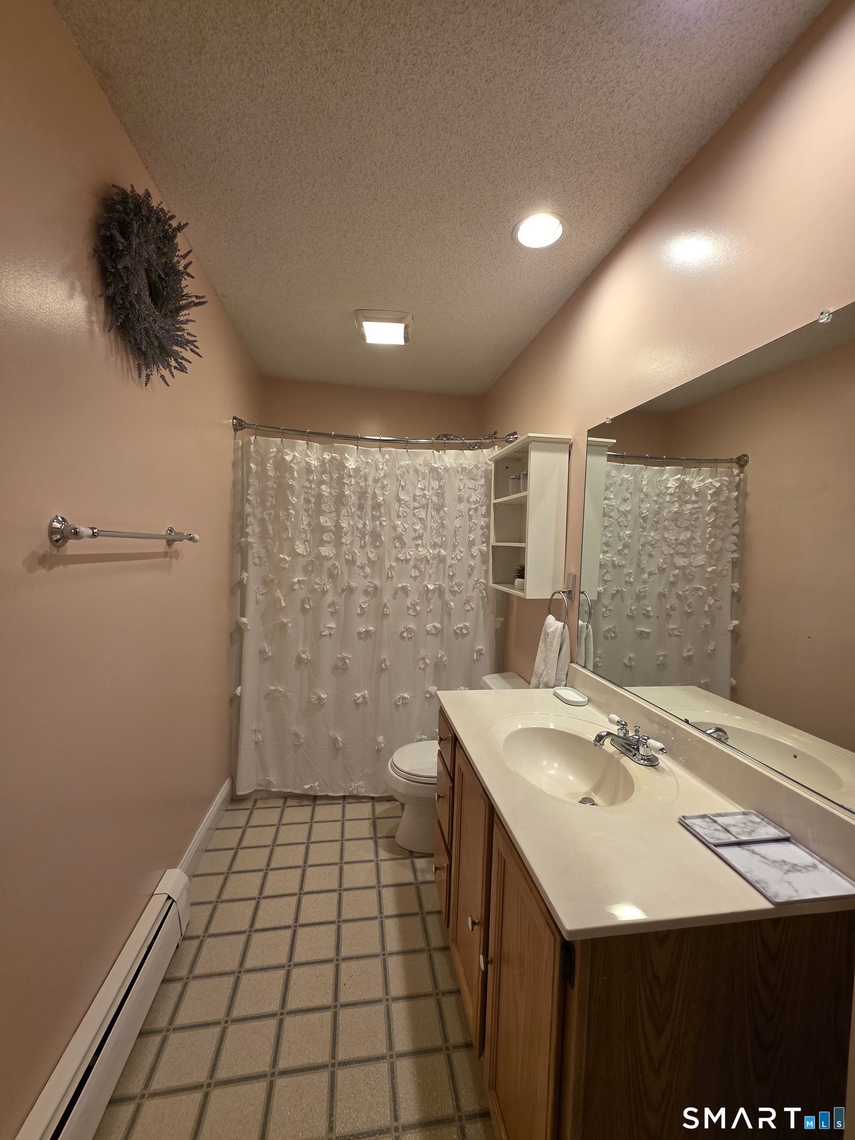83 Chelsea Court Torrington, CT 06790 - Photo 25 of 39 a bathroom with a sink a toilet and a large mirror
