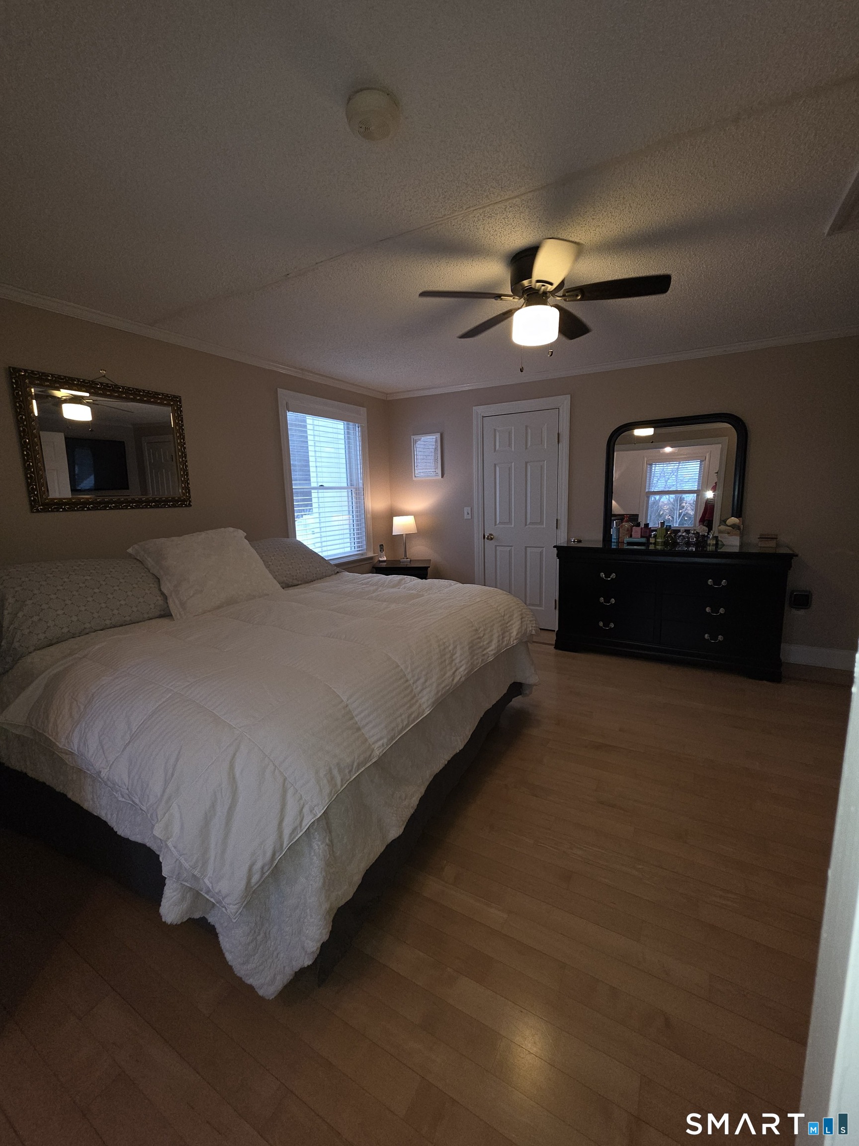 83 Chelsea Court Torrington, CT 06790 - Photo 29 of 39 a bedroom with a bed and a chandelier