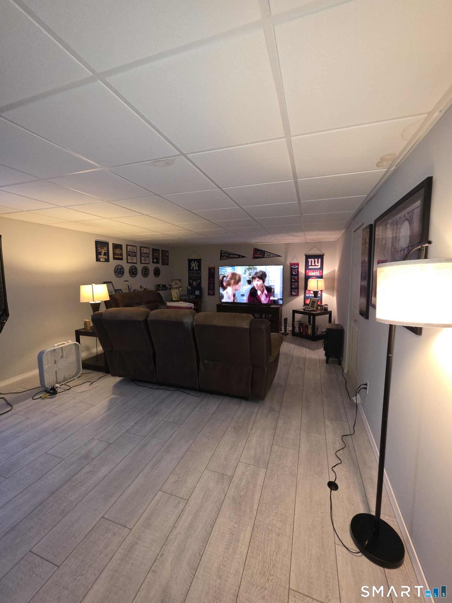 83 Chelsea Court Torrington, CT 06790 - Photo 38 of 39 a living room with furniture and a wooden floor