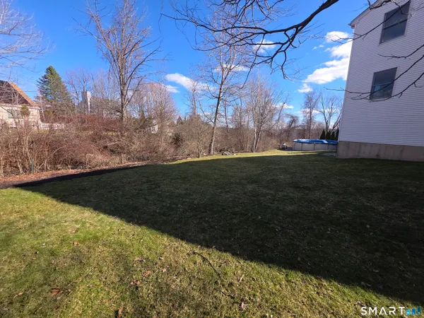 a large kitchen with wooden floors and stainless steel appliances