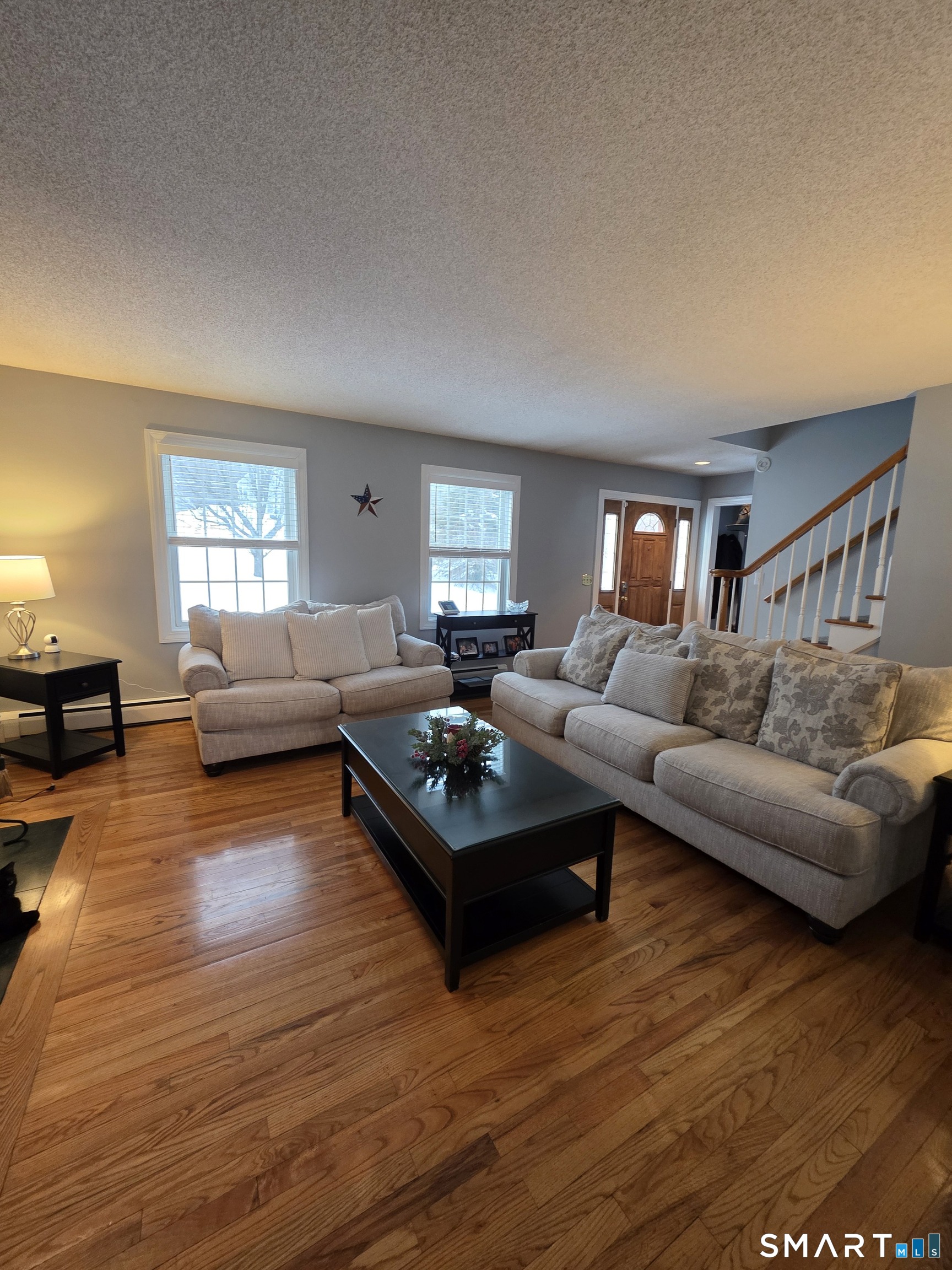 83 Chelsea Court Torrington, CT 06790 - Photo 10 of 39 a living room with furniture and a wooden floor