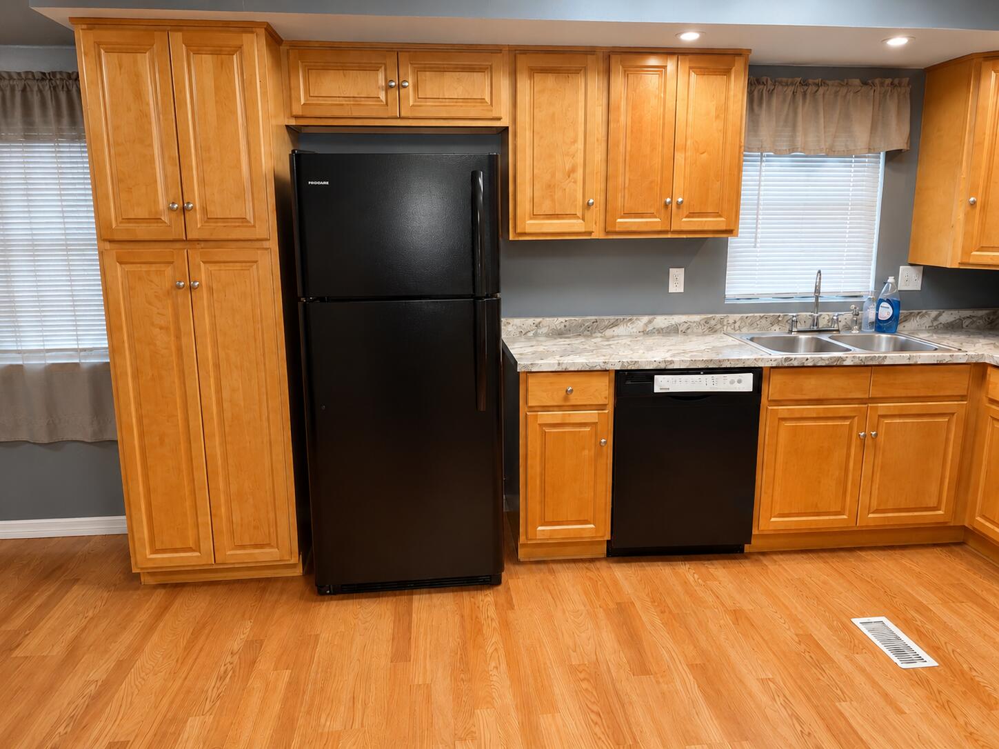 2547 Chatham Way Northeast Palm Bay, FL 32905 - Photo 16 of 24 a kitchen with granite countertop wooden cabinets a refrigerator and a sink