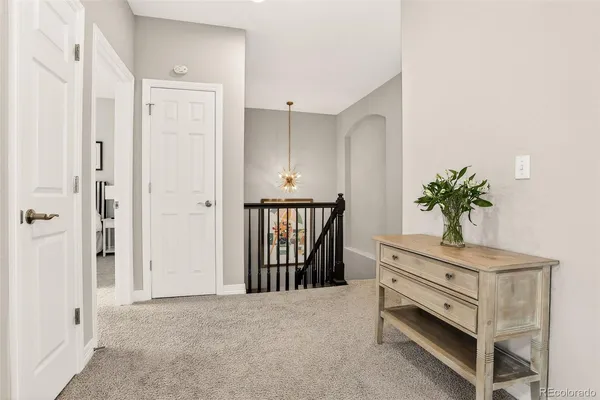 a spacious bedroom with a bed and large windows