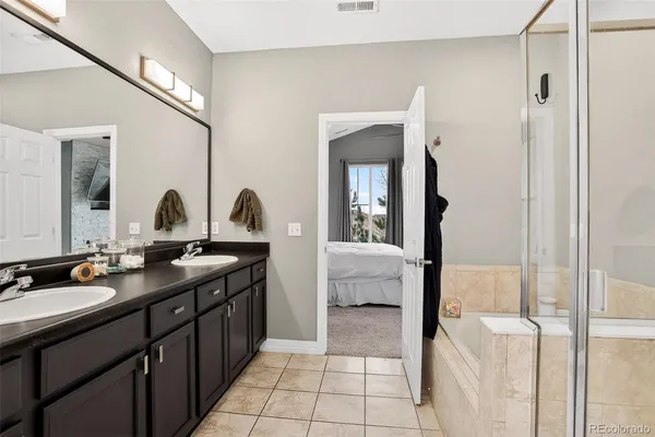 a view of a bedroom with closet and mirror