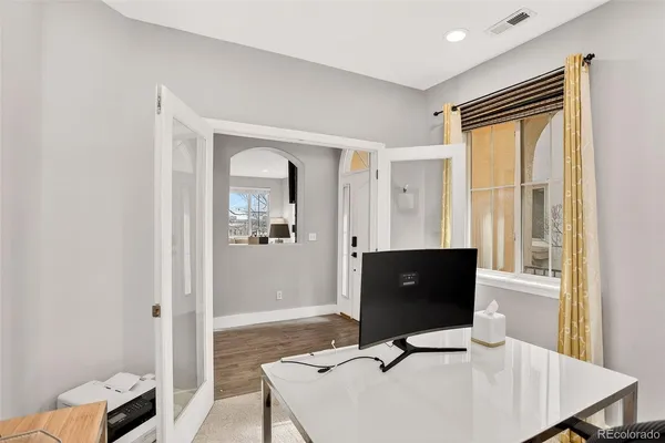 a living room with table and flat screen tv