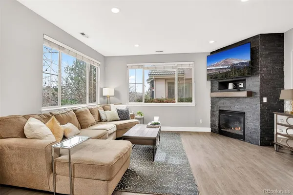 a living room with furniture window and a fireplace