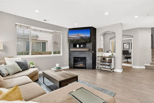 a living room with furniture and a fireplace