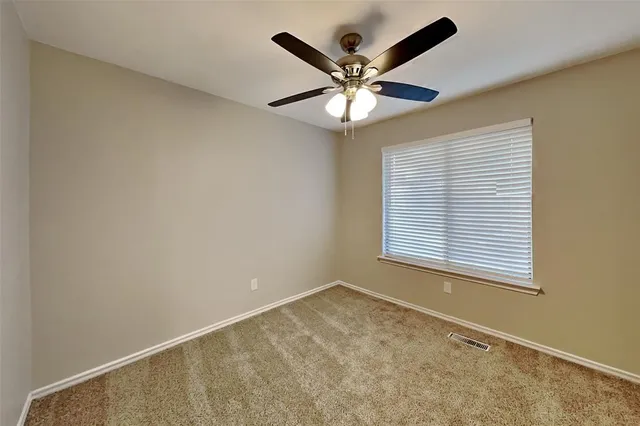 a view of a big room with wooden floor and windows in a room