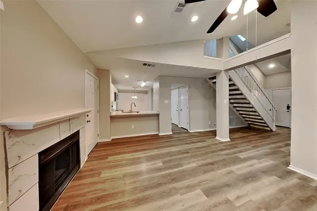 a view of a kitchen with a sink and a fireplace