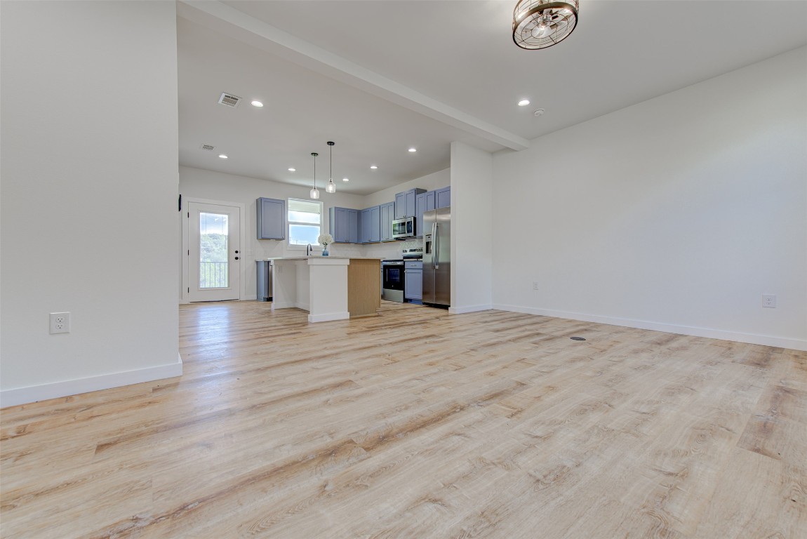 18414 Roundrock Road Jonestown, TX 78645 - Photo 11 of 30 Unfurnished living room with recessed lighting and light wood finished floors