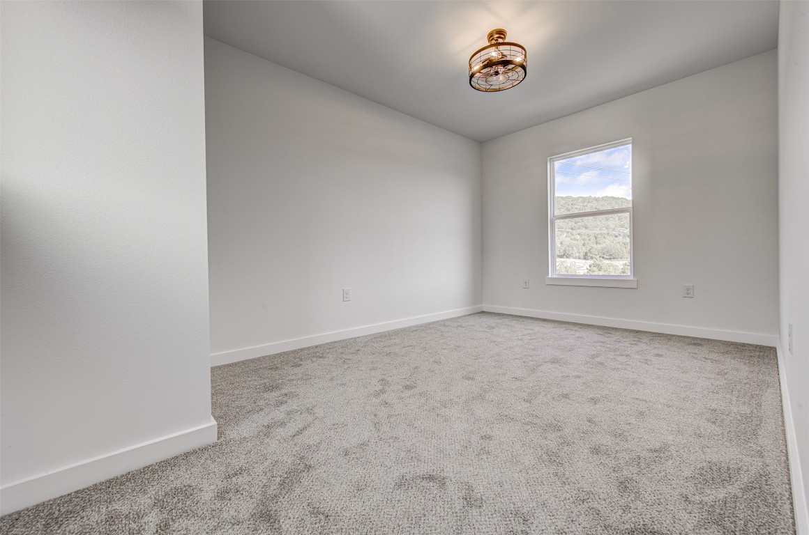 18414 Roundrock Road Jonestown, TX 78645 - Photo 16 of 30 Spare room featuring carpet and baseboards