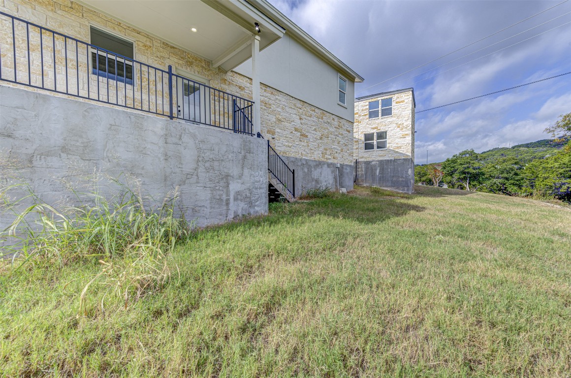 18414 Roundrock Road Jonestown, TX 78645 - Photo 29 of 30 View of grassy yard featuring stairway and a balcony