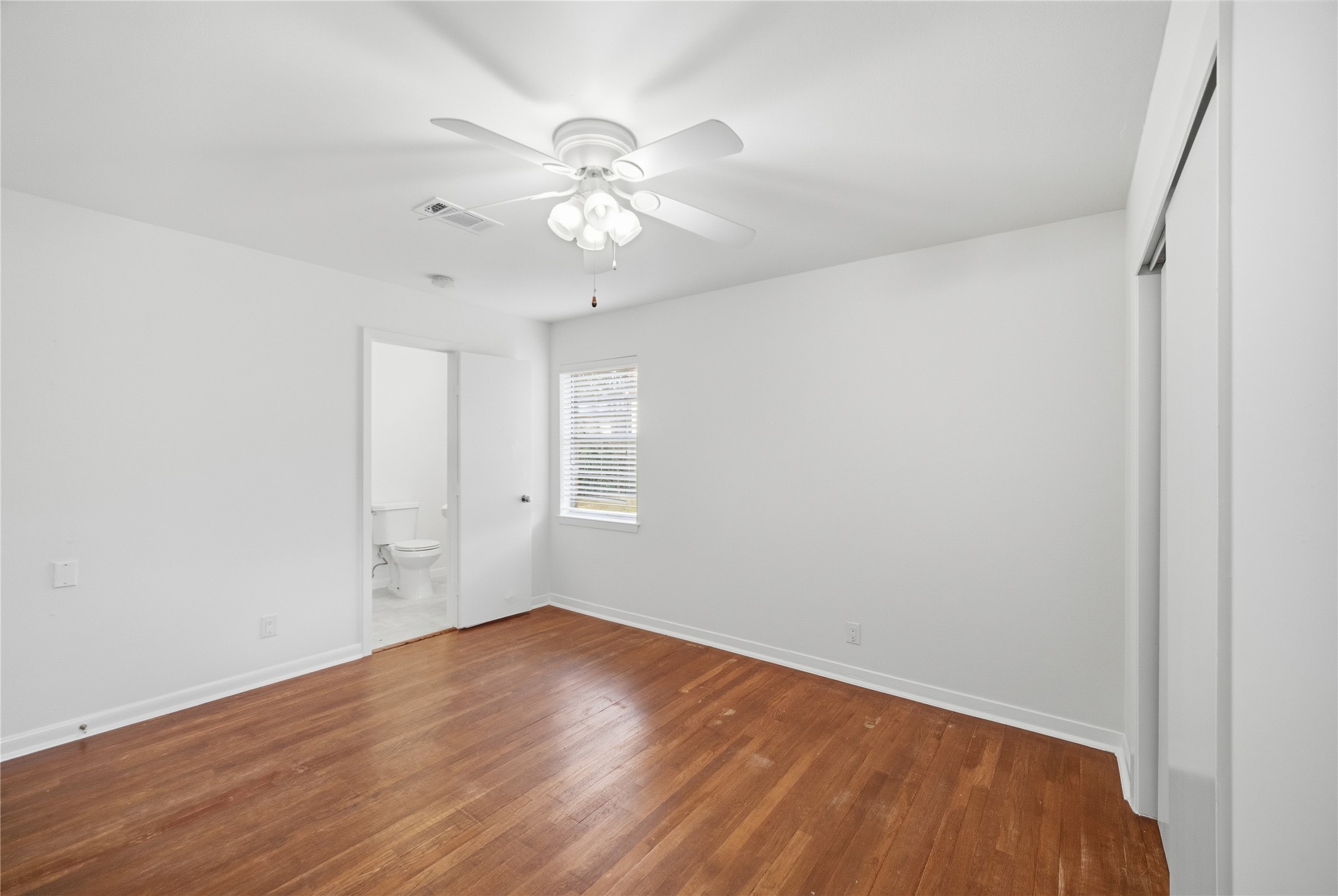 9524 Truscon Drive Houston, TX 77080 - Photo 12 of 30 wooden floor in an empty room with a window