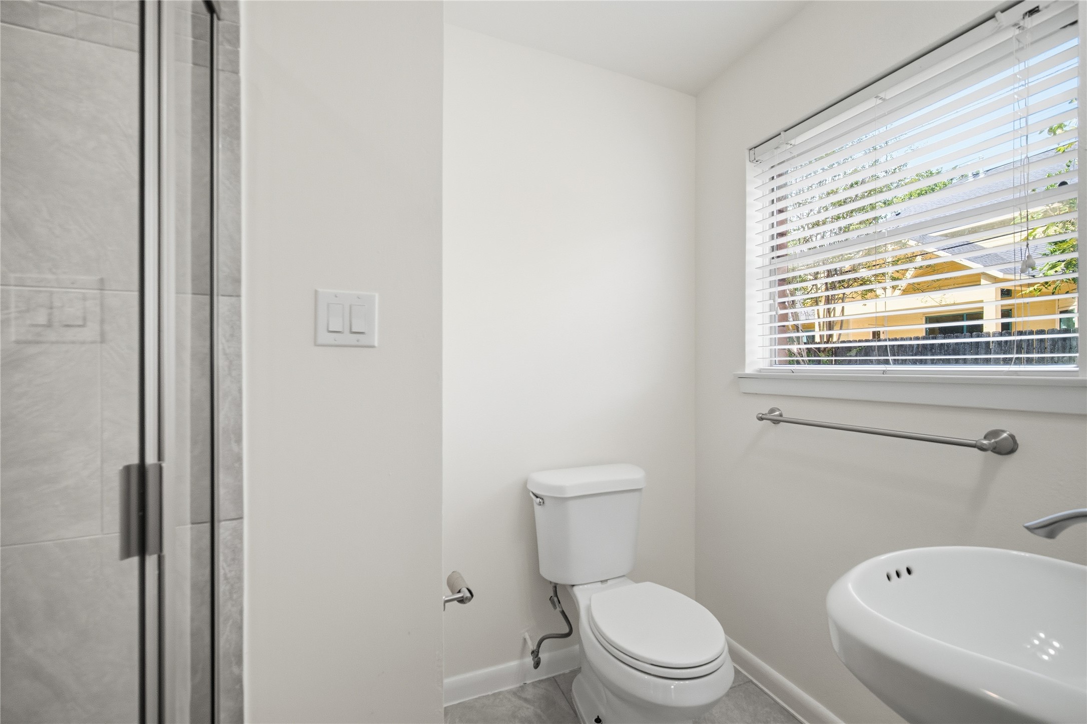9524 Truscon Drive Houston, TX 77080 - Photo 13 of 30 a white toilet sitting next to a bathroom sink