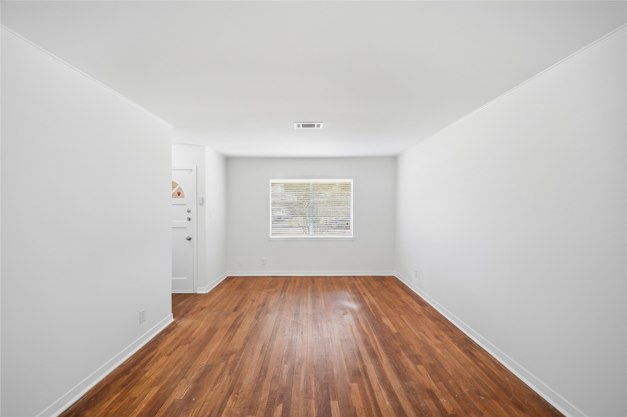 9524 Truscon Drive Houston, TX 77080 - Photo 3 of 30 a view of an empty room with wooden floor and a window