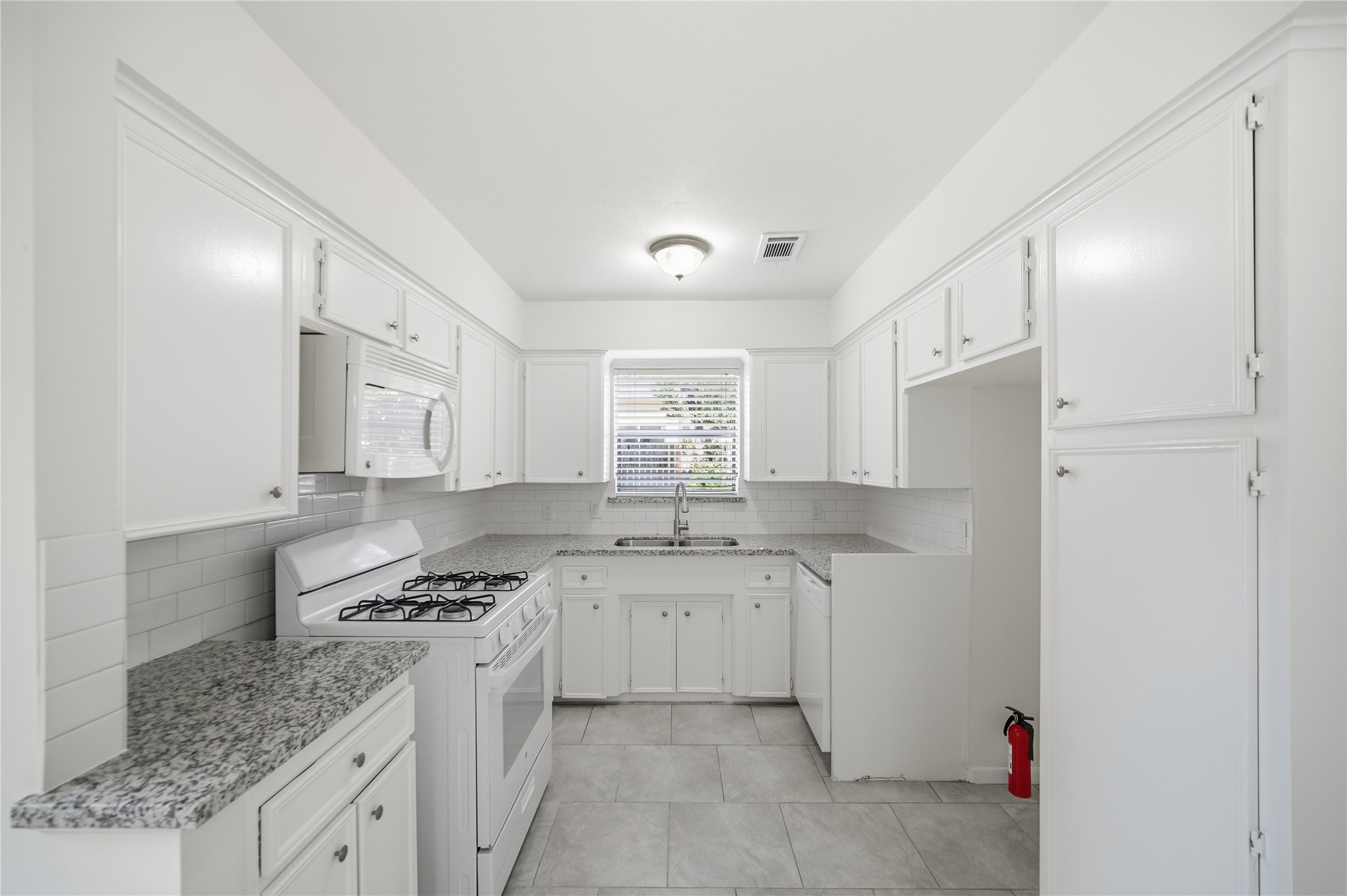 9524 Truscon Drive Houston, TX 77080 - Photo 8 of 30 a kitchen with granite countertop a sink cabinets and stainless steel appliances
