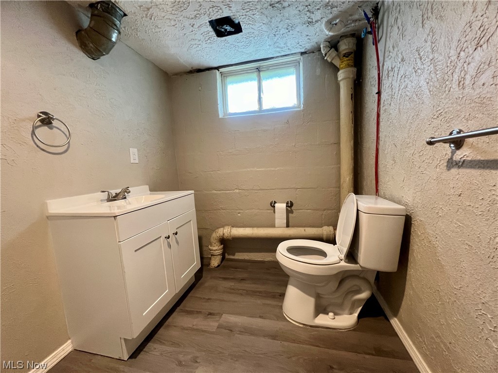 3923 Jaeger Road Lorain, OH 44053 - Photo 28 of 34 finished Bathroom in the basement with dark hardwood flooring, vanity, and a textured ceiling