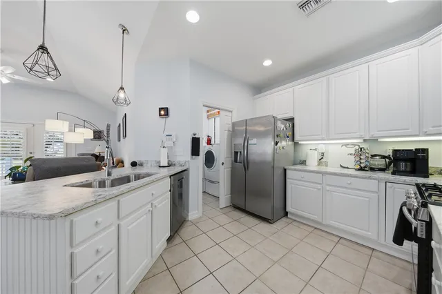 a kitchen with refrigerator and cabinets