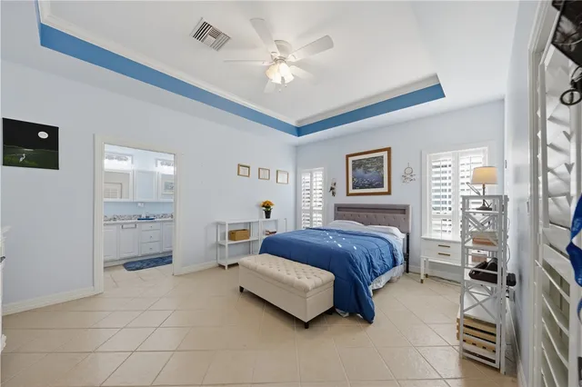 a spacious bedroom with a bed and a chandelier