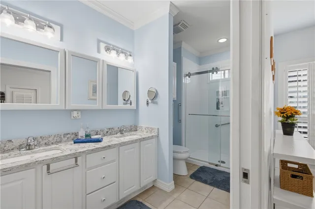 a bathroom with a granite countertop sink mirror and toilet