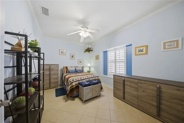 a bedroom with a bed and ceiling fan