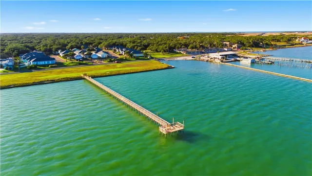 an aerial view of a houses with a lake view