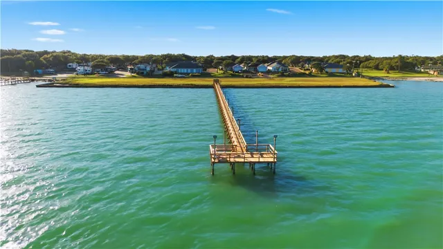 a view of a lake with a table and chairs