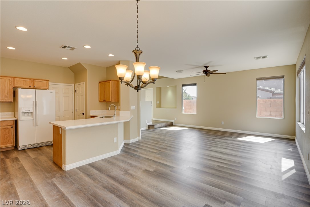 703 Principle Point Avenue Henderson, NV 89012 - Photo 7 of 29 An open concept living area features resilient wood-look flooring and ample natural light.