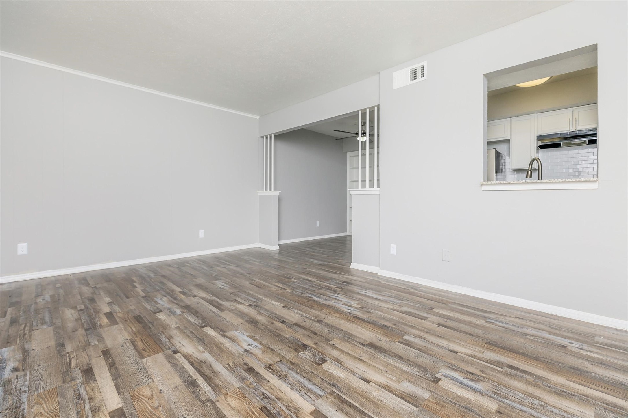 1212 Hampshire Lane, Unit 2091 Richardson, TX 75080 - Photo 11 of 40 an empty room with wooden floor and windows