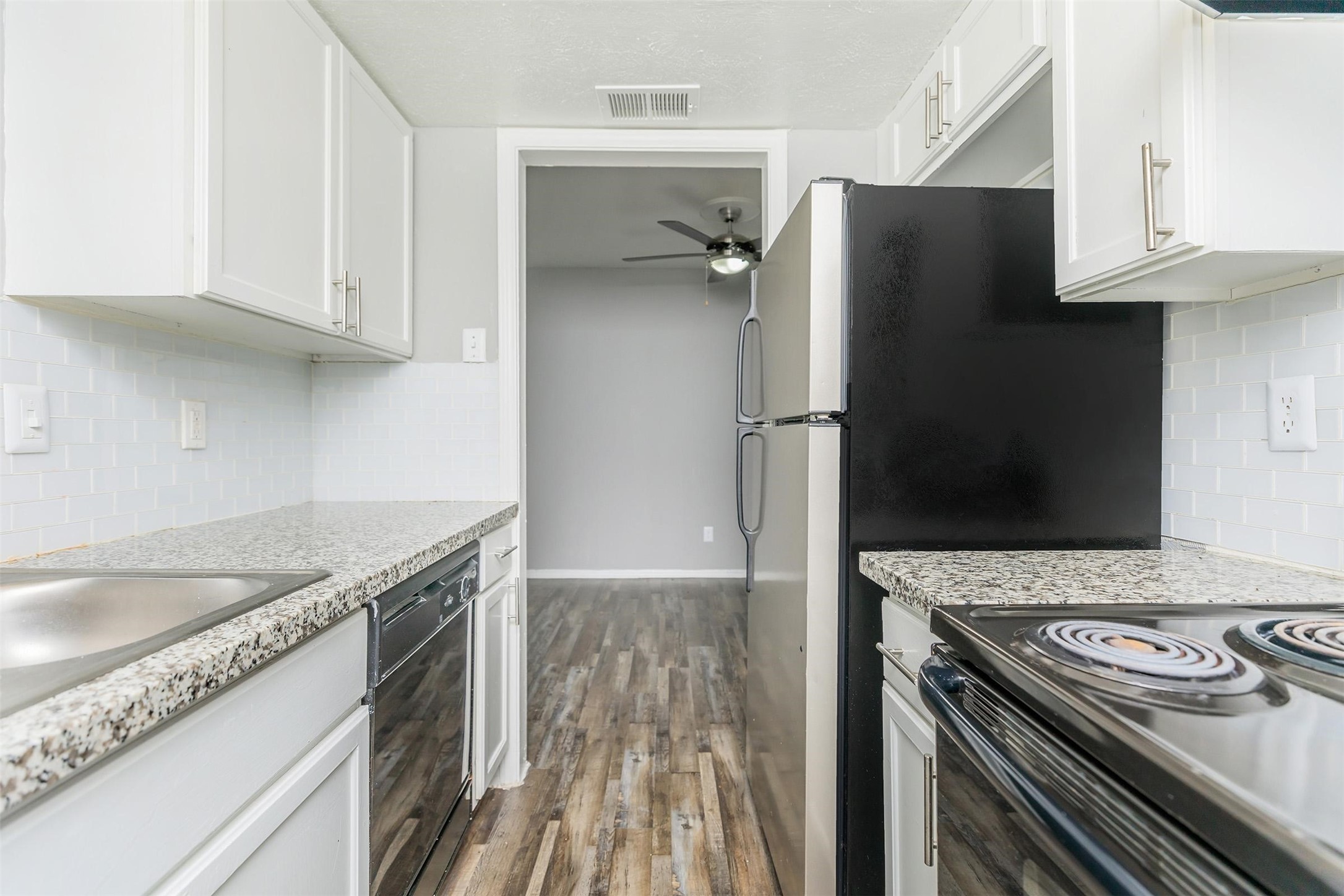 1212 Hampshire Lane, Unit 2091 Richardson, TX 75080 - Photo 14 of 40 a kitchen with granite countertop a sink stove and refrigerator